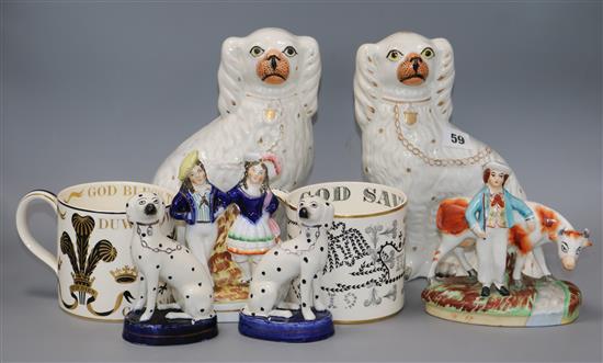 A pair of Staffordshire spaniels, a pair of Dalmatians, two Staffordshire groups and a pair of Wedgwood commemorative mugs by Guyatt